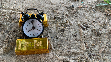 gold bar and clock, perfect for financial planning or investment, photo conceptの写真素材