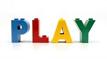 Colorful bricks spell out PLAY against white backdropの素材