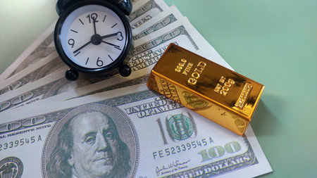 mini clock, gold bars and usd banknotes, investment or savings, photo conceptの写真素材