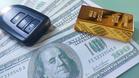 car keys, gold bar and banknotes usd, investment or saving, photo conceptの写真素材