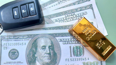 car keys, gold bar and banknotes usd, investment or saving, photo conceptの写真素材