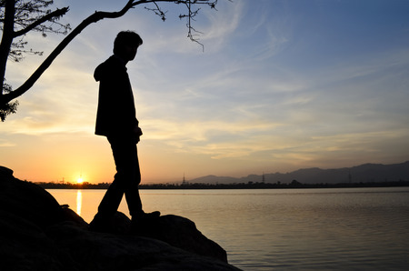 Silhouette of a man on sunsetの写真素材