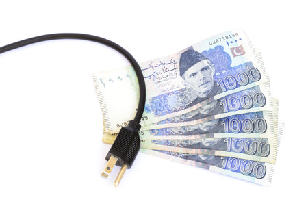 Pakistani thousand rupee notes and electric plug. Electricity cost conceptの写真素材