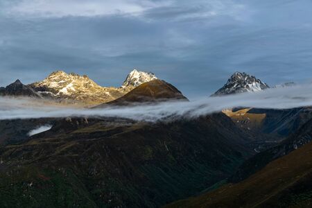 a beautiful mountain view with fog and clouds