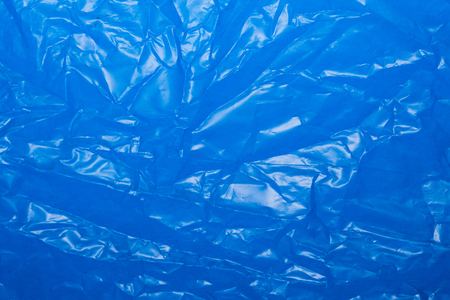 Wrinkled blue plastic sheet for background or textの写真素材