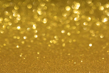 Golden defocused flickering lights for text and backgroundの写真素材