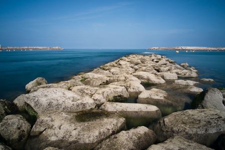 Natural stones stretching into the distance of the sea bayの写真素材