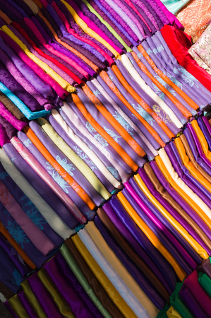 Traditional Moroccan fabric stacked in a marketの写真素材