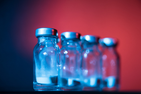 Bottles for injection with white powder on a color backgroundの写真素材