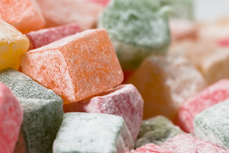 Pieces of multicolored Turkish Delight in powdered sugar.の写真素材