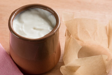 White homemade yogurt in a clay jar.の写真素材