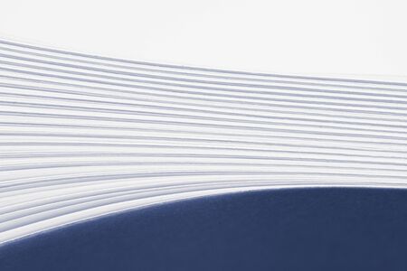 Bent stack of white paper sheets. Conceptual background of folded office forms.