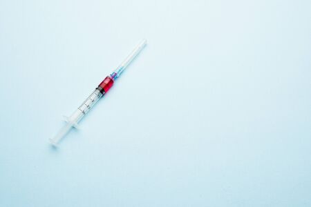 Syringe with a dose. Portion injection on a light background.