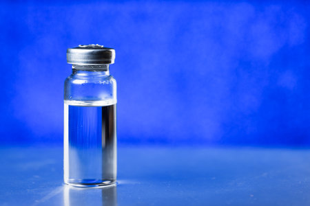 Medical ampoule for injection on blue. Medicine for vaccination.の写真素材
