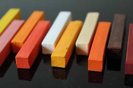 Multi-colored, rectangular sticks of art chalk.