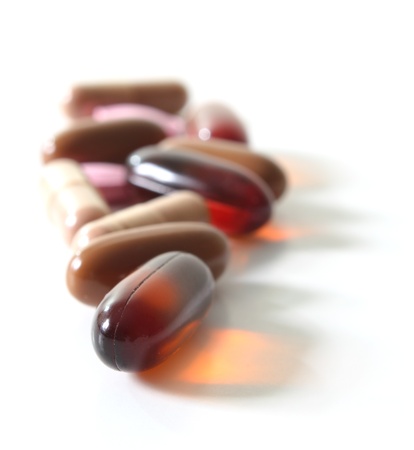 Depth of field shot of multiple vitamins over white.の写真素材