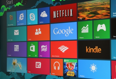 Close up, angled shot of the new Windows 8 start screen on a desktop computer.