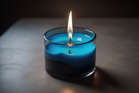 Burning aroma candle on wooden table against solid color background, copyspace. ai generativeの素材