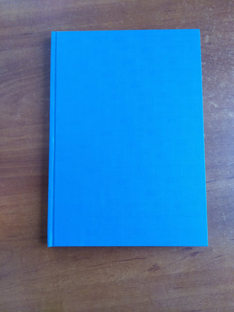 Blank blue book on wooden backgroundの写真素材