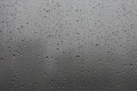 The rain drums on the glassの写真素材