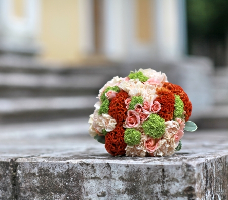 bouquet of bright flowers on the stone stepsの写真素材