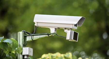 outdoor surveillance video camera on a green background