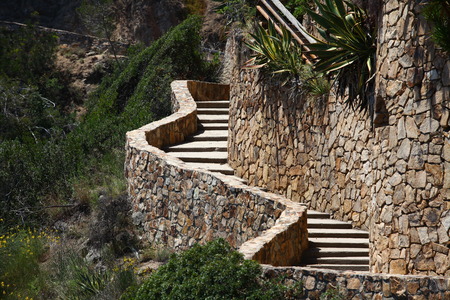 A stone staircase winds up a steep