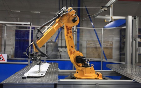 Industrial robotic arm in electronics production lineの写真素材