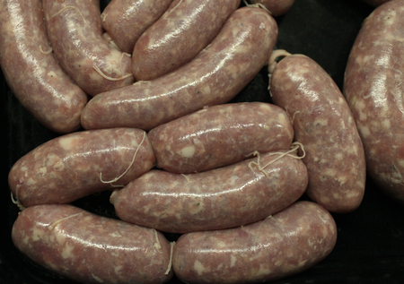 raw meat sausages on black background  above close-upの写真素材