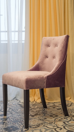 contemporary upholstered chair upholstered in fabric at the windowの写真素材