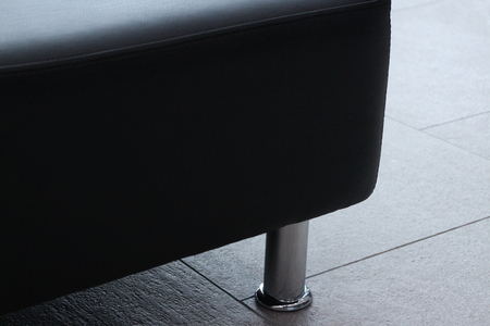 massive leather sofa with chrome leg close toの写真素材