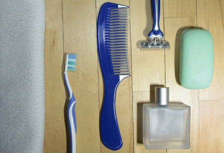 men's toiletries on wooden floor close toの写真素材