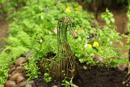 garden bed with decorative figure of a gooseの写真素材