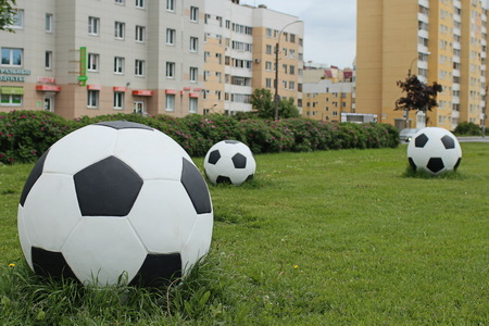 three soccer balls on the green lawn garden design, cityscapeの写真素材
