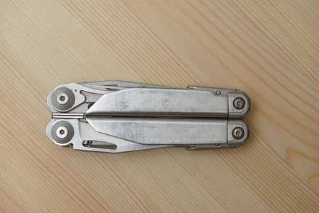 pocket Multitool knife on a wooden background
