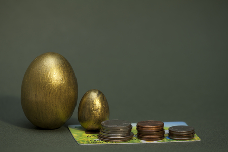 stack of coins and golden eggs growing の写真素材