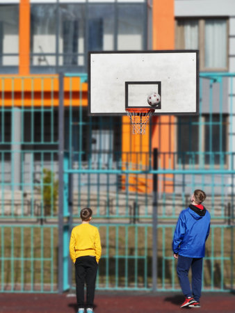 teenagers playing basketball on the playgroundのeditorial素材