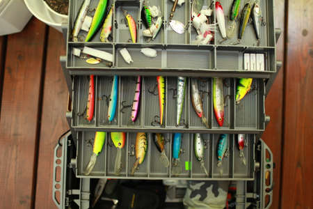 fisherman is inspects, checks the fishing box