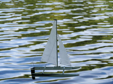 small sailing catamaran on the waves children's toy sailingの写真素材