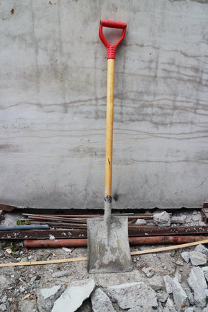 shovel leaned against the wall at a construction siteの写真素材