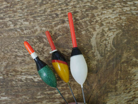 three large fishing floats on a wooden background close up, still life