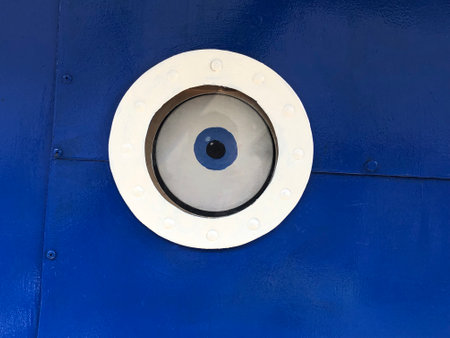 An eye in a round porthole, the concept of the all-seeing eyeの写真素材