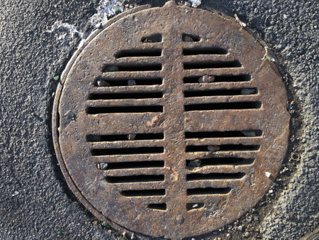cast iron sewer manhole cover close-upの写真素材