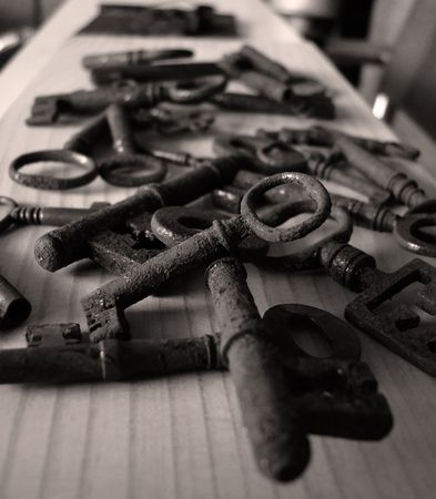 Heap of rusty and useless keys from the locks which have sunk into oblivion together with doors.の写真素材