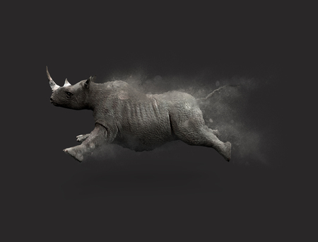 A Rhino moving and jumping with dust particle effect on gray background, 3d illustrationの写真素材