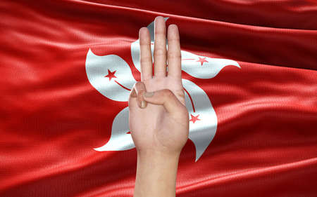 3d Illustration of a hand showing 3 fingers, a political symbol, on Hong Kong flag background, as an act of resistance against Military Government in Hong Kong. Hong Kong political situation.の写真素材
