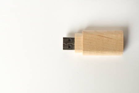 A wooden flash drive against white backgroundの写真素材