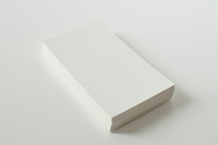 A stack of white blank calling cards against white background