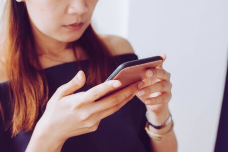 A young woman is using a mobile phoneの写真素材