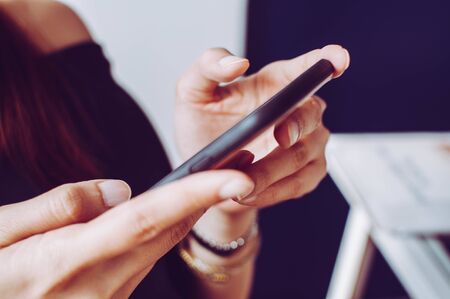 A young woman is using a mobile phoneの写真素材